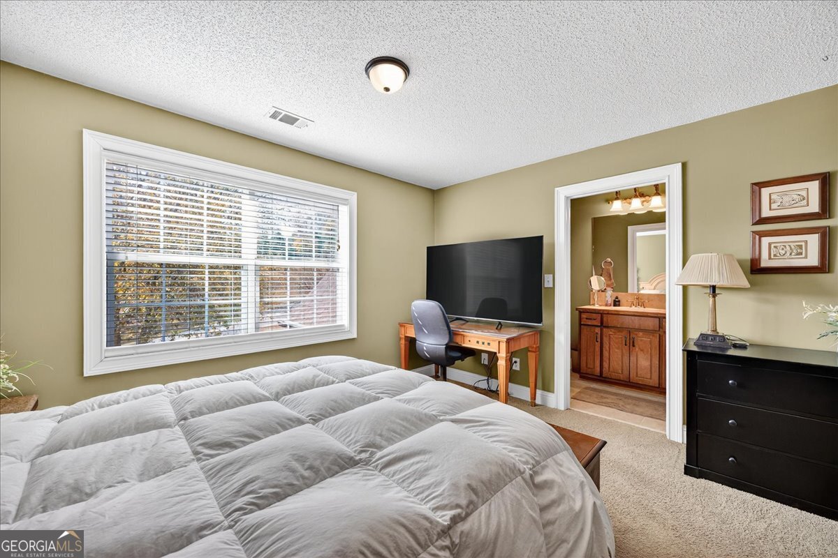 518 River Overlook Forsyth, GA 31029 - Photo 25 of 85 a bedroom with a bed and a flat screen tv