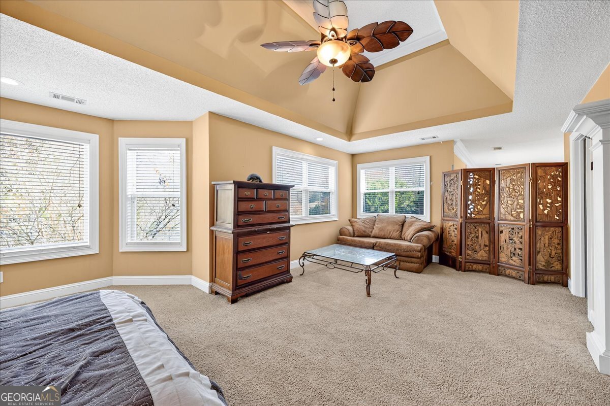 518 River Overlook Forsyth, GA 31029 - Photo 29 of 85 a living room with furniture a ceiling fan and a large window