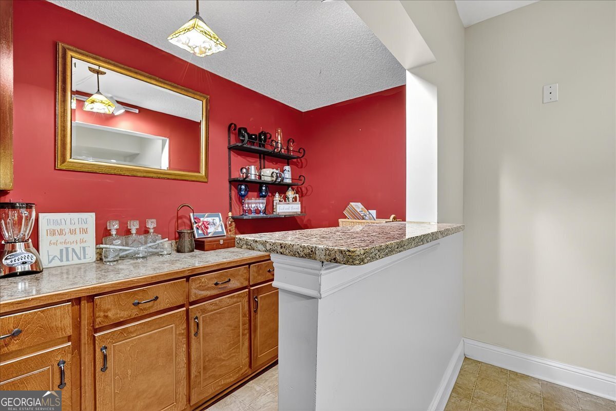 518 River Overlook Forsyth, GA 31029 - Photo 40 of 85 a kitchen with stainless steel appliances granite countertop a sink and a microwave