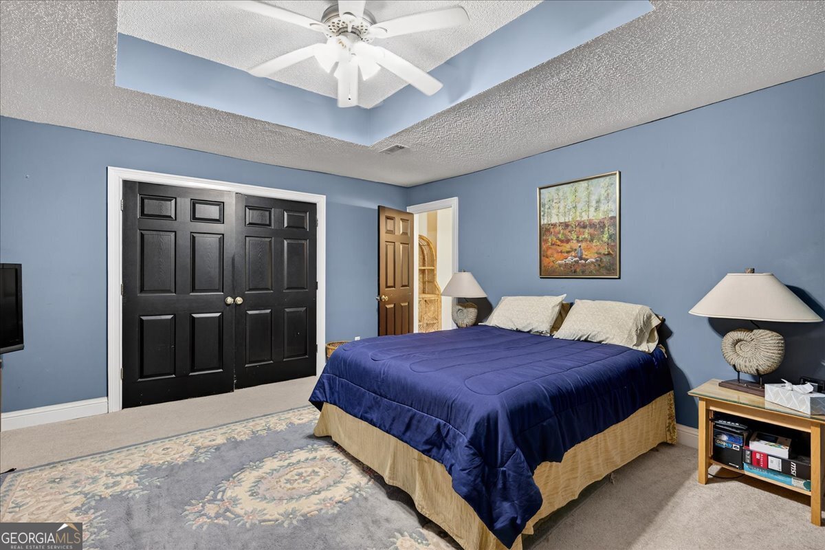 518 River Overlook Forsyth, GA 31029 - Photo 42 of 85 a bedroom with a bed and a chandelier