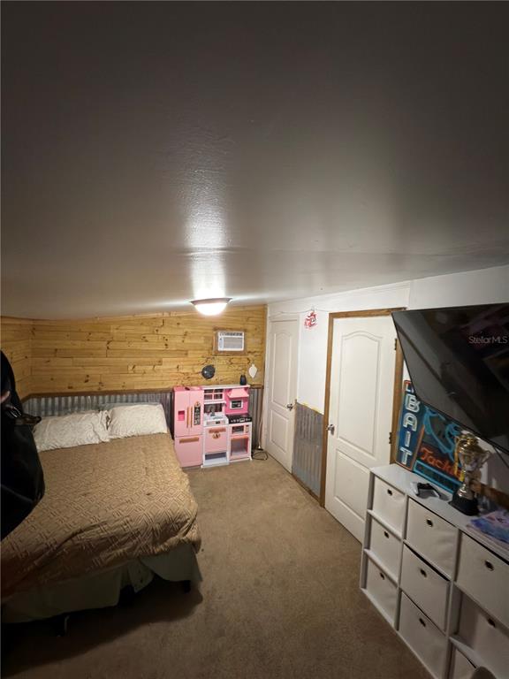 5500 South Chamberlain Pool Avenue Homosassa, FL 34448 - Photo 6 of 7 a bedroom with furniture and a flat screen tv