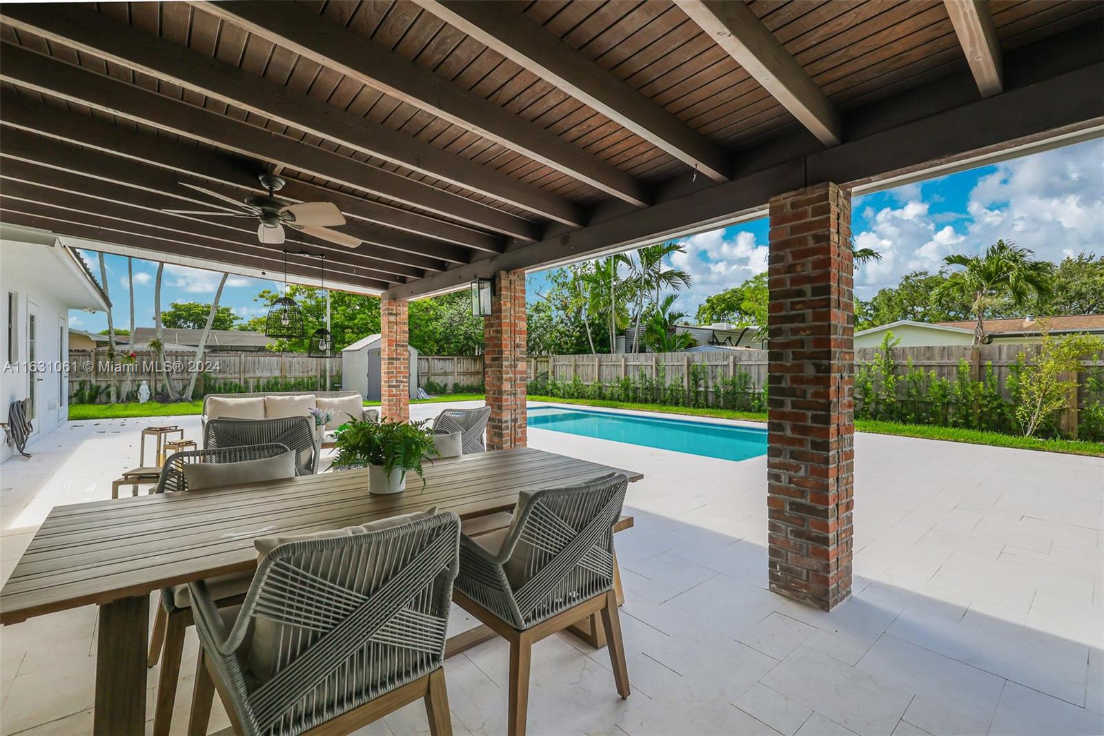 10900 Southwest 128th Street Miami, FL 33186 - Photo 11 of 34 a patio with a table chairs and a barbeque