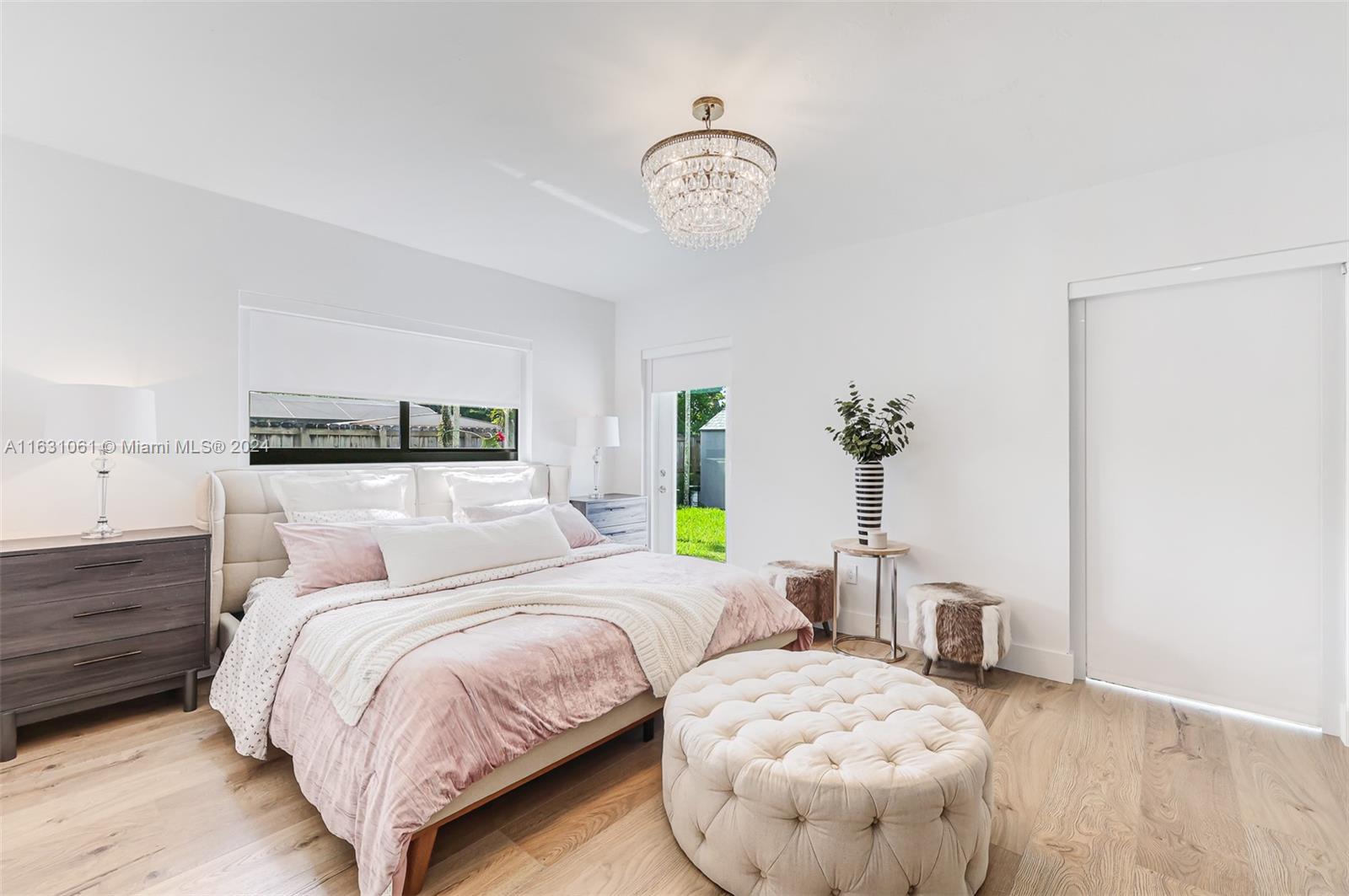 10900 Southwest 128th Street Miami, FL 33186 - Photo 19 of 34 a bedroom with a bed and chandelier