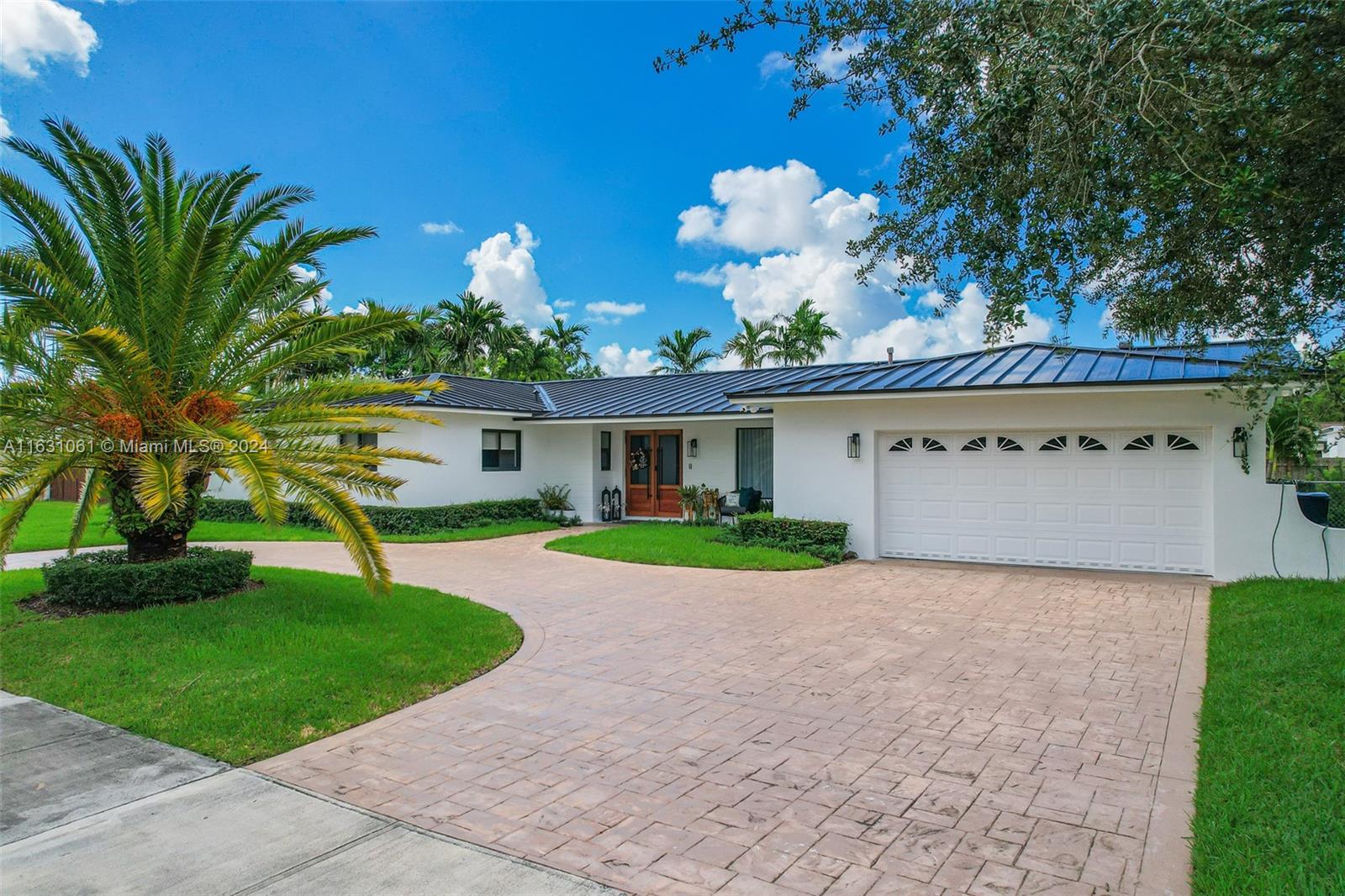 10900 Southwest 128th Street Miami, FL 33186 - Photo 2 of 34 a view of a house with a yard and a garden