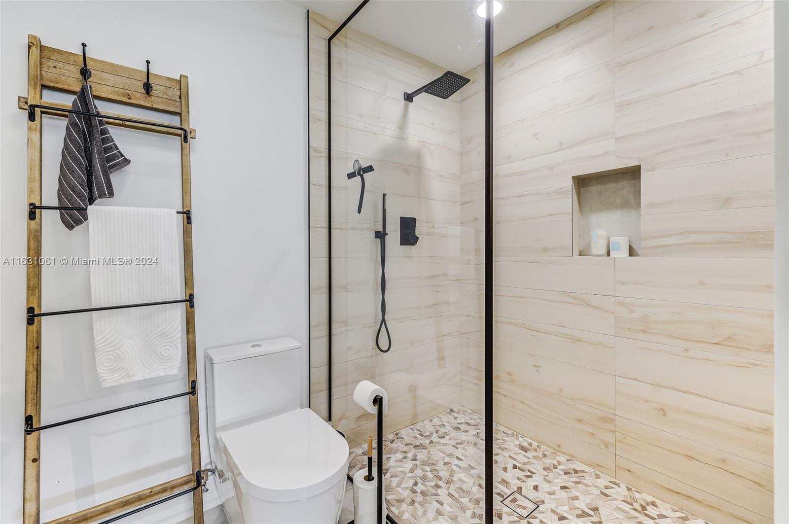 10900 Southwest 128th Street Miami, FL 33186 - Photo 21 of 34 a bathroom with a granite countertop toilet and a shower
