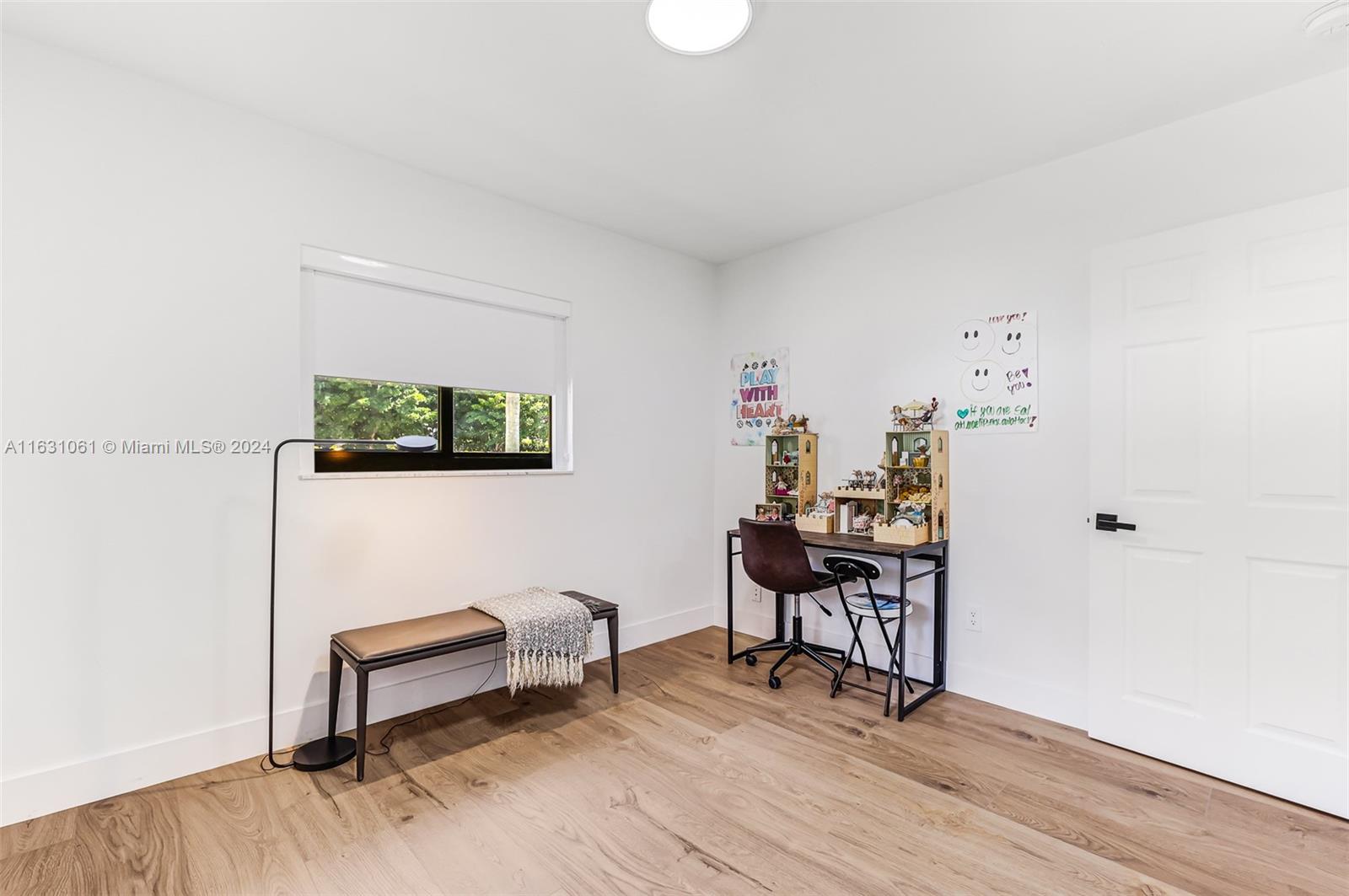 10900 Southwest 128th Street Miami, FL 33186 - Photo 25 of 34 a view of a workspace with furniture and wooden floor