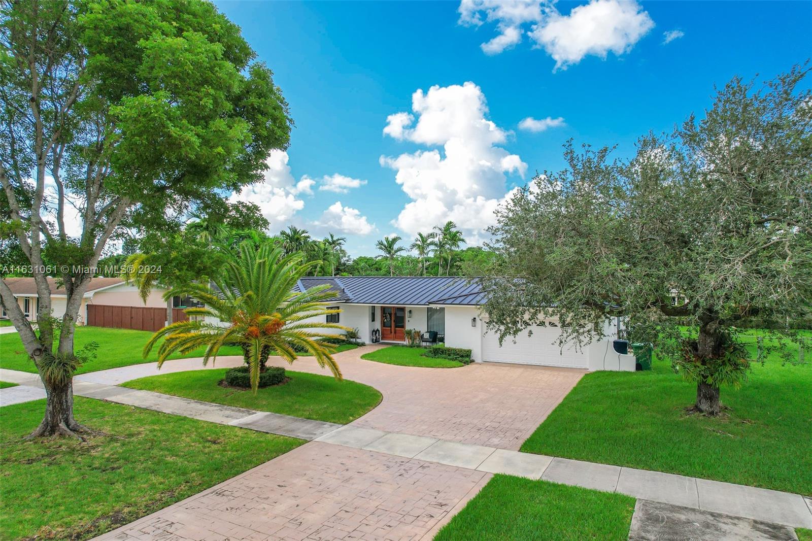10900 Southwest 128th Street Miami, FL 33186 - Photo 3 of 34 a front view of a house with a yard
