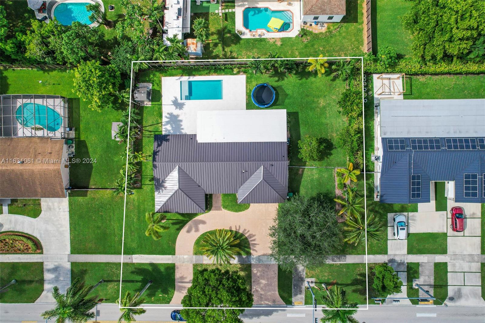 10900 Southwest 128th Street Miami, FL 33186 - Photo 8 of 34 an aerial view of a house with a garden and swimming pool