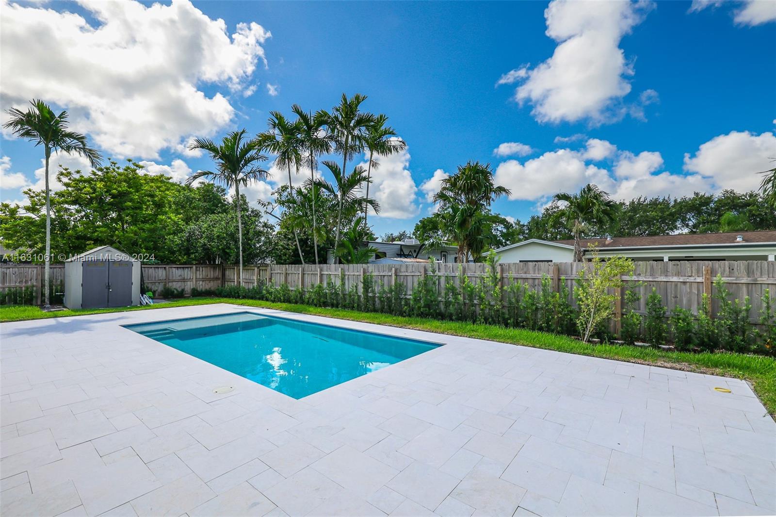 10900 Southwest 128th Street Miami, FL 33186 - Photo 9 of 34 a view of swimming pool with a yard and palm trees