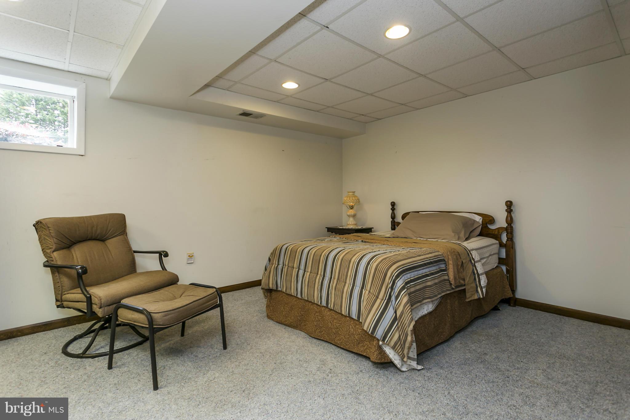 10009 German Road Ellicott City, MD 21042 - Photo 21 of 27 a spacious bedroom with a bed and a chair