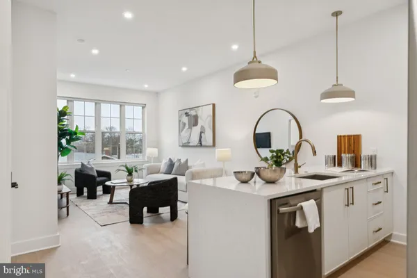 a living room with stainless steel appliances granite countertop furniture a fireplace a rug and a window
