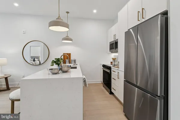 a kitchen with stainless steel appliances a refrigerator sink and stove
