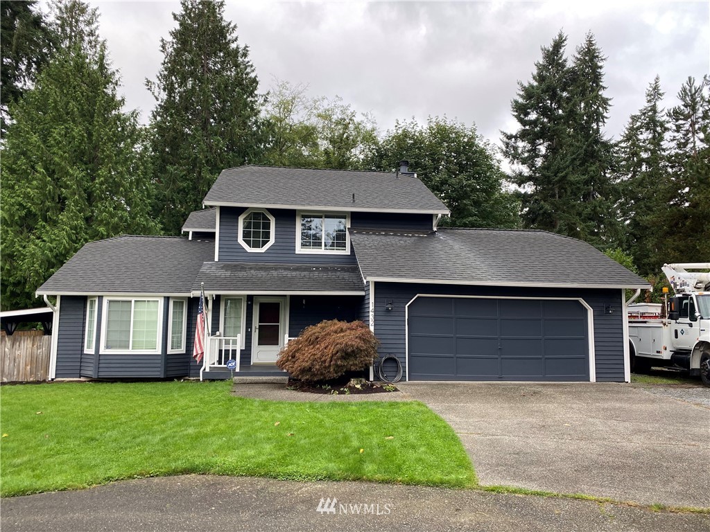 1432 234th Street Southwest Bothell, WA 98021 - Photo 1 of 1 a front view of a house with a garden and garage