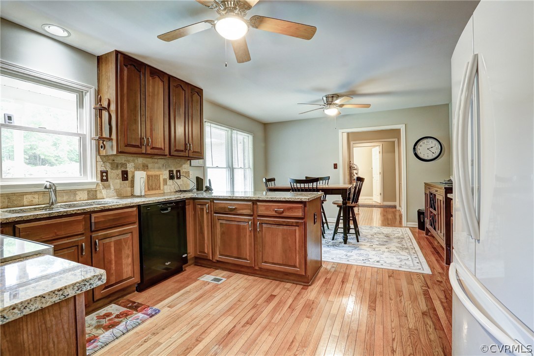 2511 Fairground Road Maidens, VA 23102 - Photo 12 of 29 a kitchen with stainless steel appliances granite countertop wooden floors a stove and a window