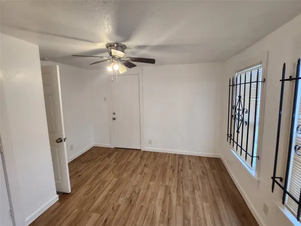 wooden floor in an empty room with a window