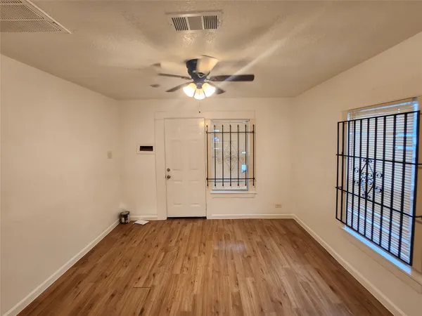 wooden floor in an empty room with a window