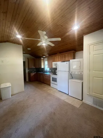 a view of kitchen with furniture and refrigerator