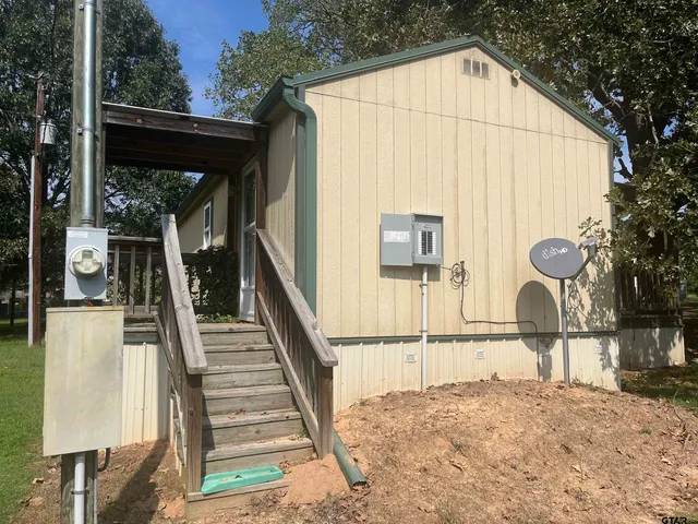 a view of a house with wooden fence