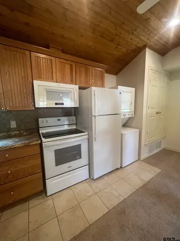 a kitchen with cabinets and stainless steel appliances
