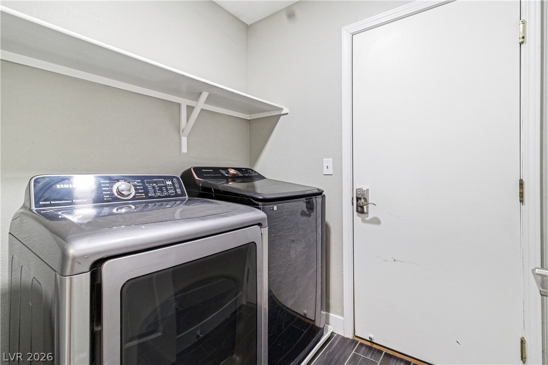 9523 Observer Street Las Vegas, NV 89123 - Photo 19 of 42 A dedicated laundry space provides optimal efficiency and convenience with modern appliances and built-in shelving.
