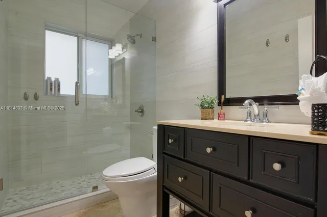 a bathroom with a sink toilet and a mirror