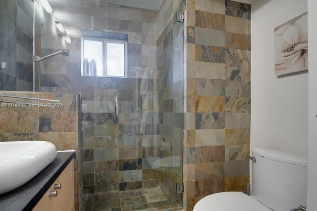 a bathroom with a shower and toilet