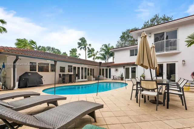 a bedroom with bed dresser and window