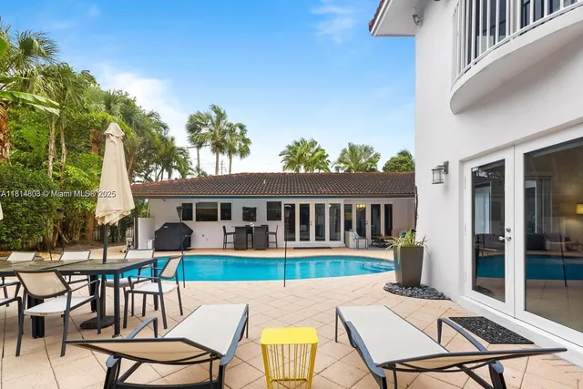 a view of a patio with dining table and chairs
