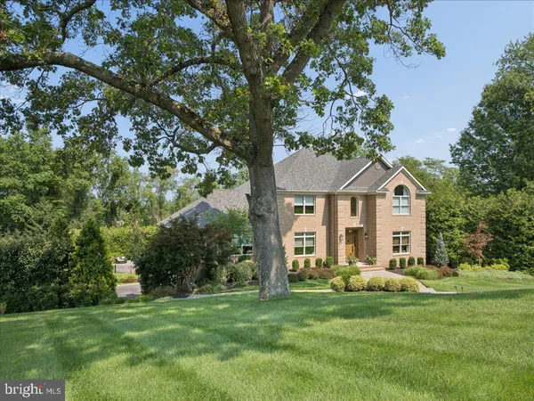 a front view of a house with yard and green space