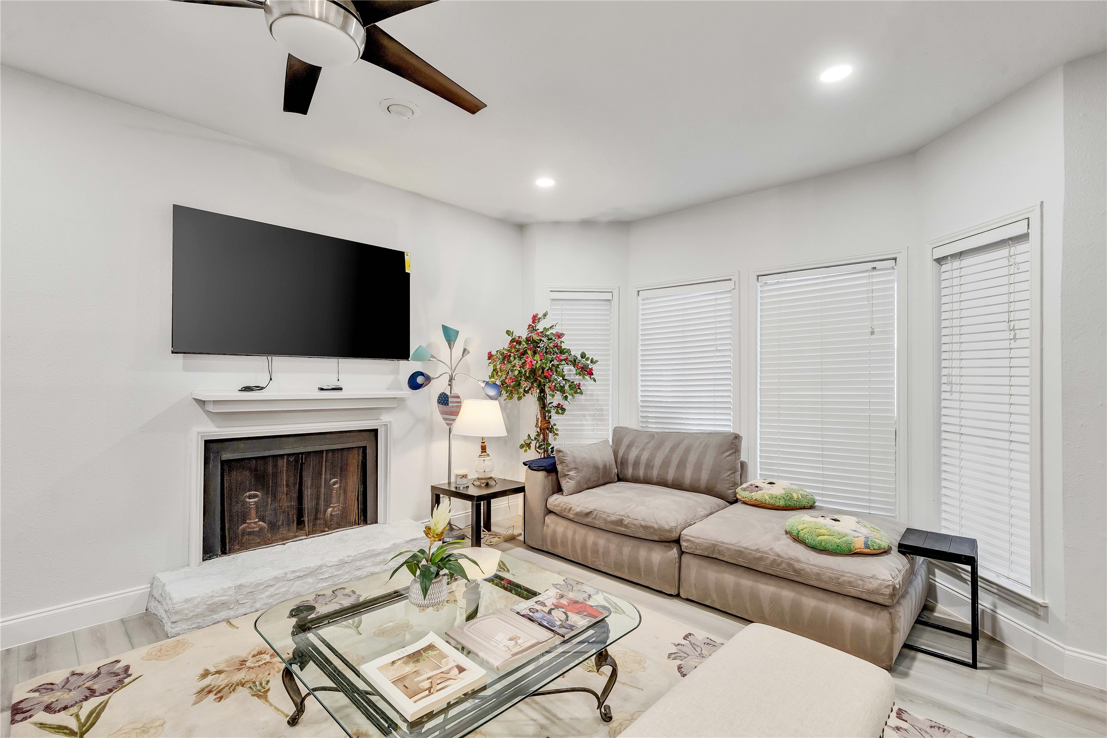 a living room with furniture a fireplace and a flat screen tv