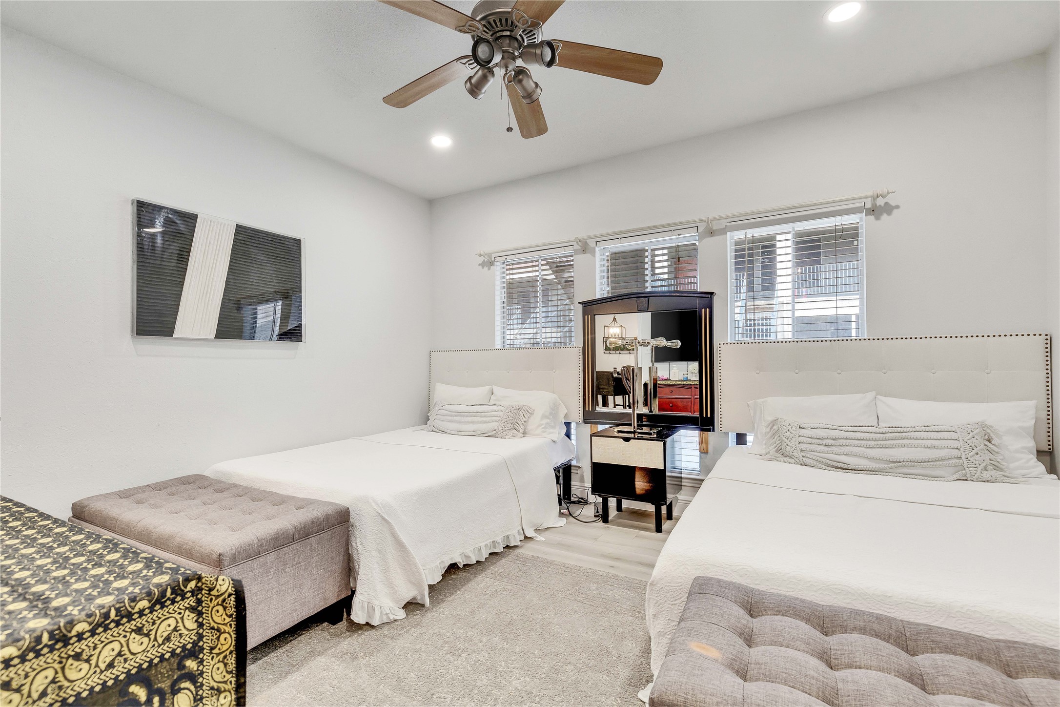 2529 Rio Grande Street, Unit 56 Austin, TX 78705 - Photo 12 of 16 a bedroom with a bed and a chandelier