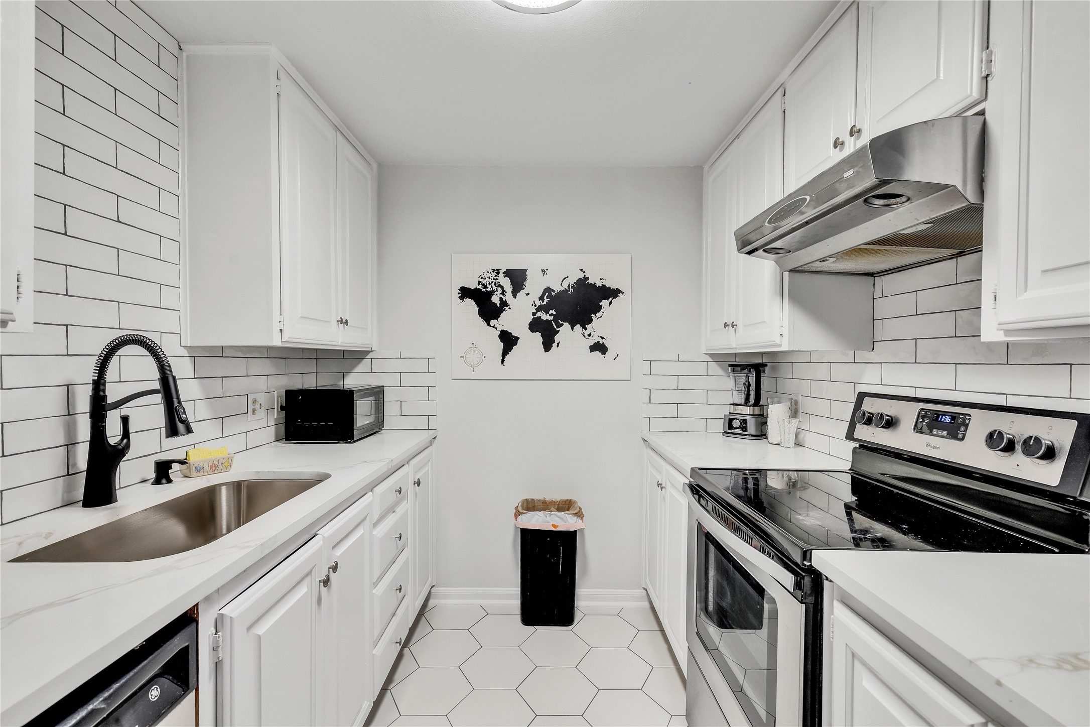 2529 Rio Grande Street, Unit 56 Austin, TX 78705 - Photo 3 of 16 a kitchen with a sink a stove and cabinets