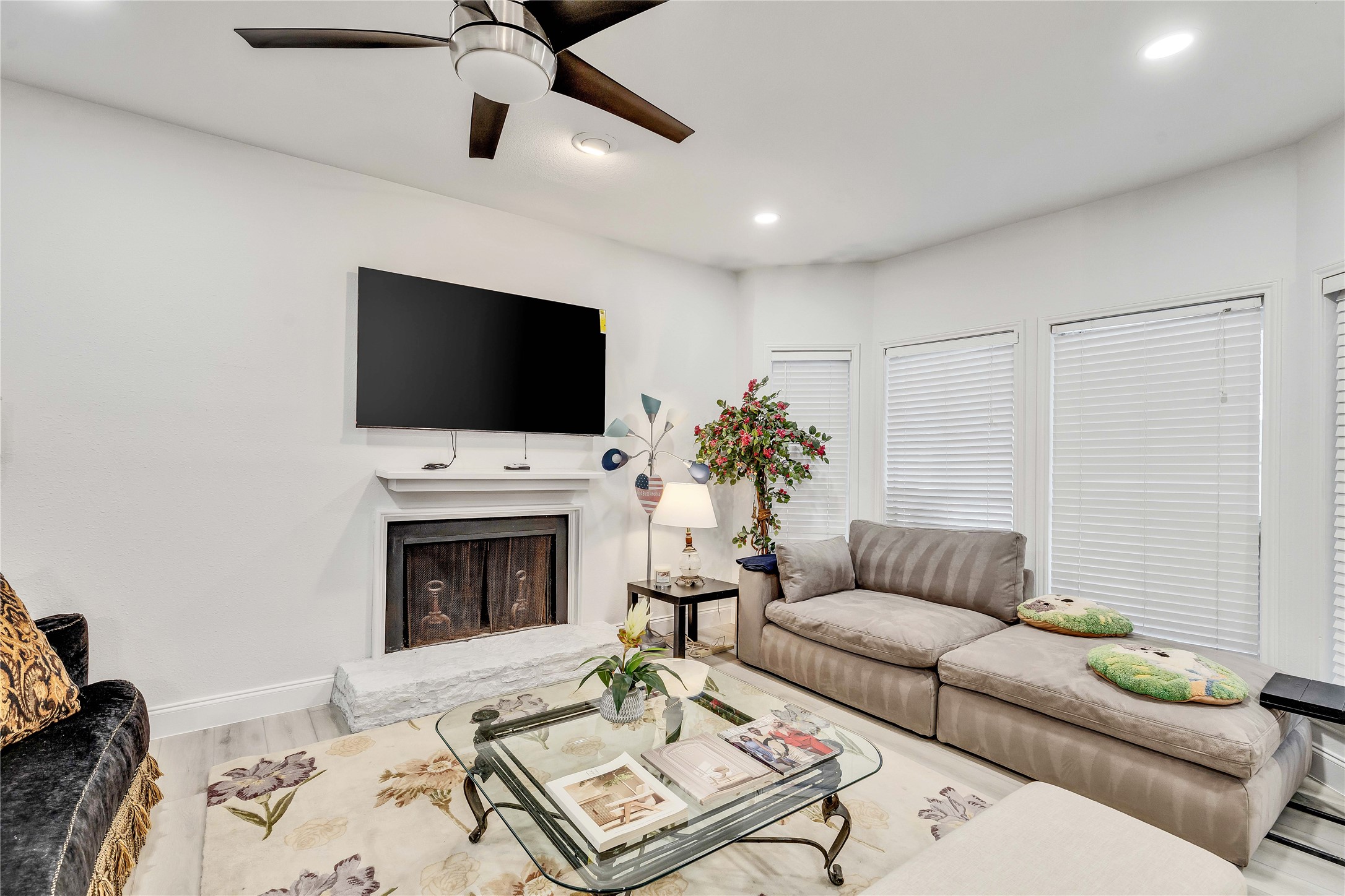2529 Rio Grande Street, Unit 56 Austin, TX 78705 - Photo 8 of 16 a living room with furniture a fireplace and a flat screen tv