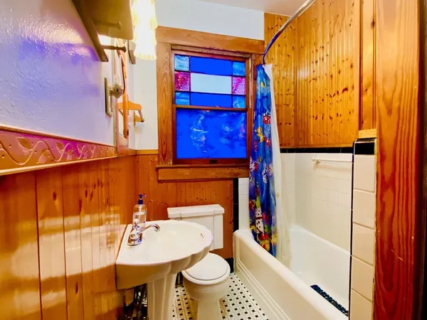 a bathroom with a sink toilet and shower