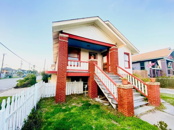 a view of front of house with deck and yard