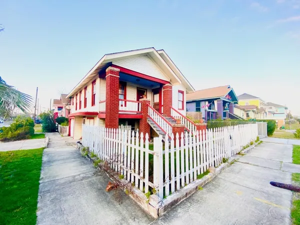 a front view of a house with wooden fence