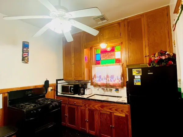 a kitchen with stainless steel appliances a stove and cabinets