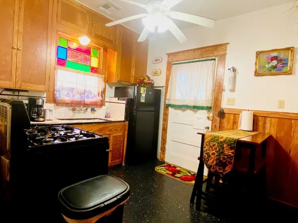a kitchen with stainless steel appliances a stove refrigerator sink and cabinets