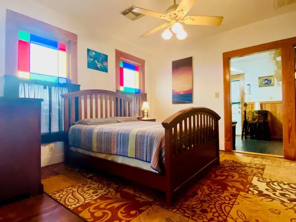 a bedroom with a bed and wooden floor