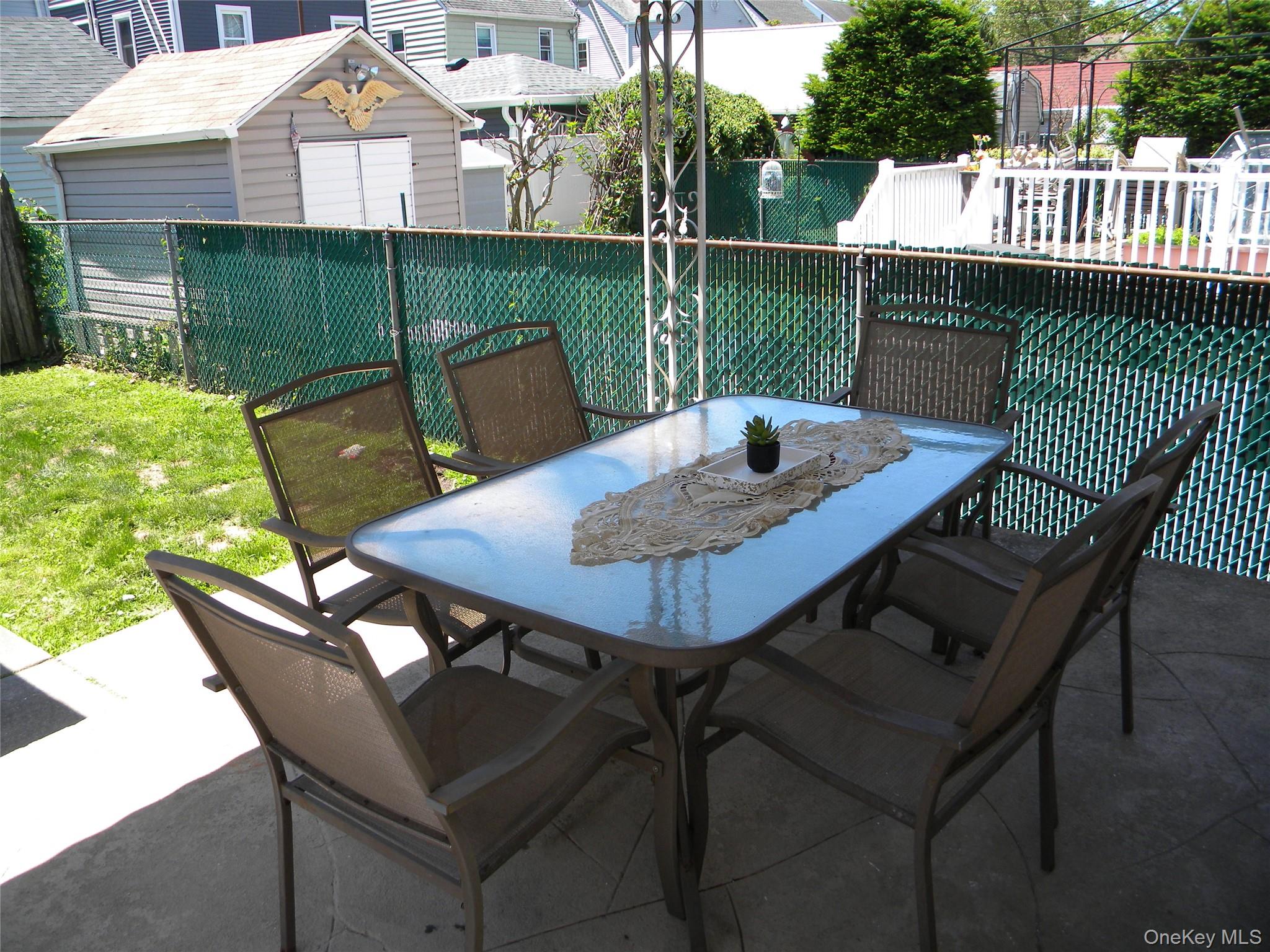 241-26 86th Road Queens, NY 11426 - Photo 31 of 38 a view of a patio with a table chairs and a table