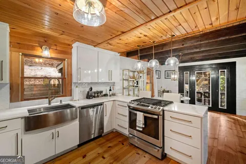a kitchen with stainless steel appliances a stove a sink and a refrigerator