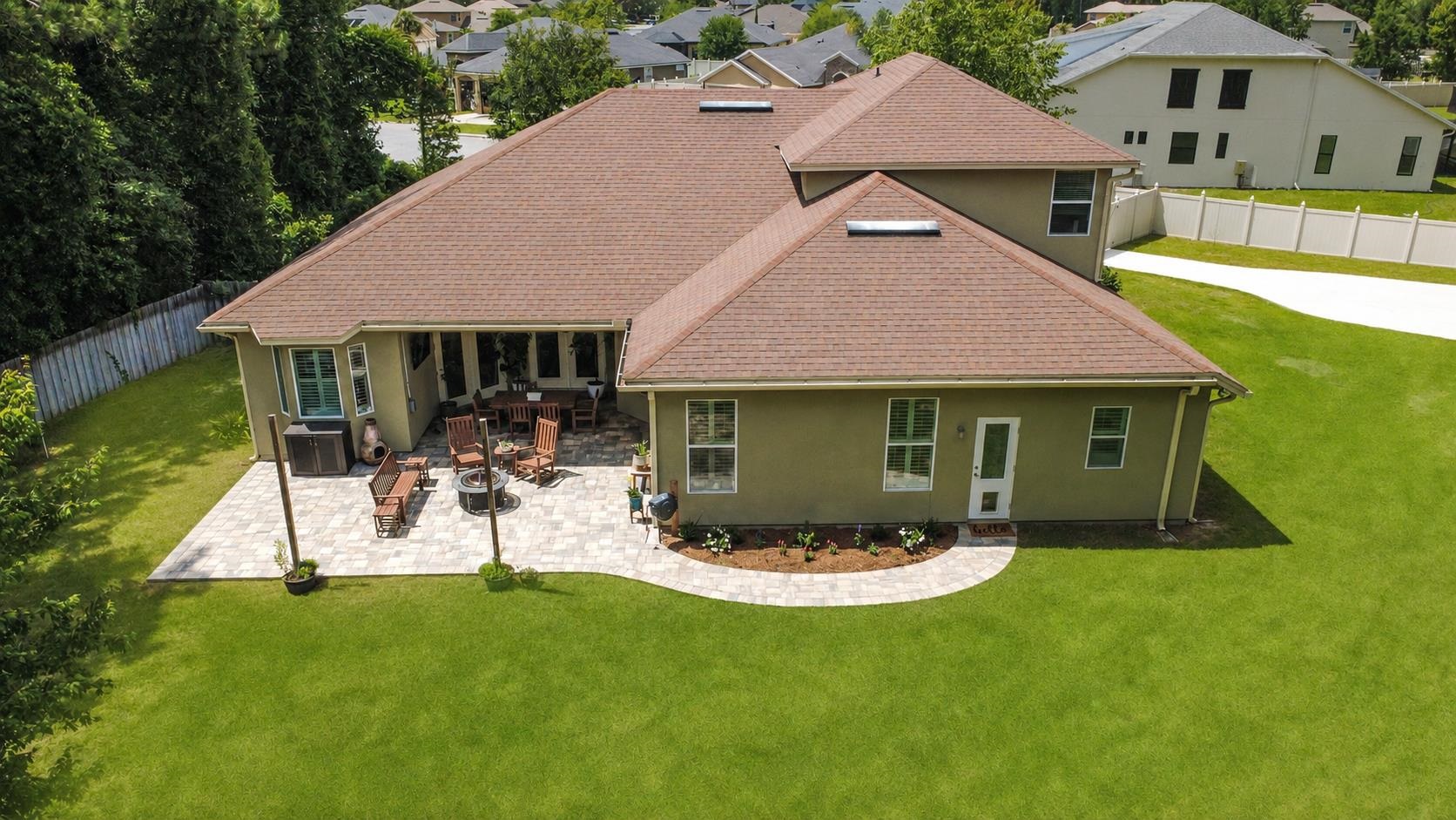 1308 Acorn Ridge Court St. Augustine, FL 32092 - Photo 43 of 47 a view of a house with table and chairs under an umbrella