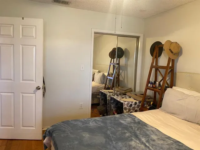 a bedroom with bed and two windows