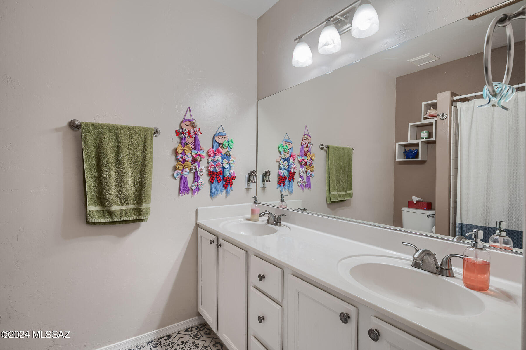 9141 East Dawn Post Road Tucson, AZ 85749 - Photo 17 of 24 a bathroom with a sink mirror and vanity