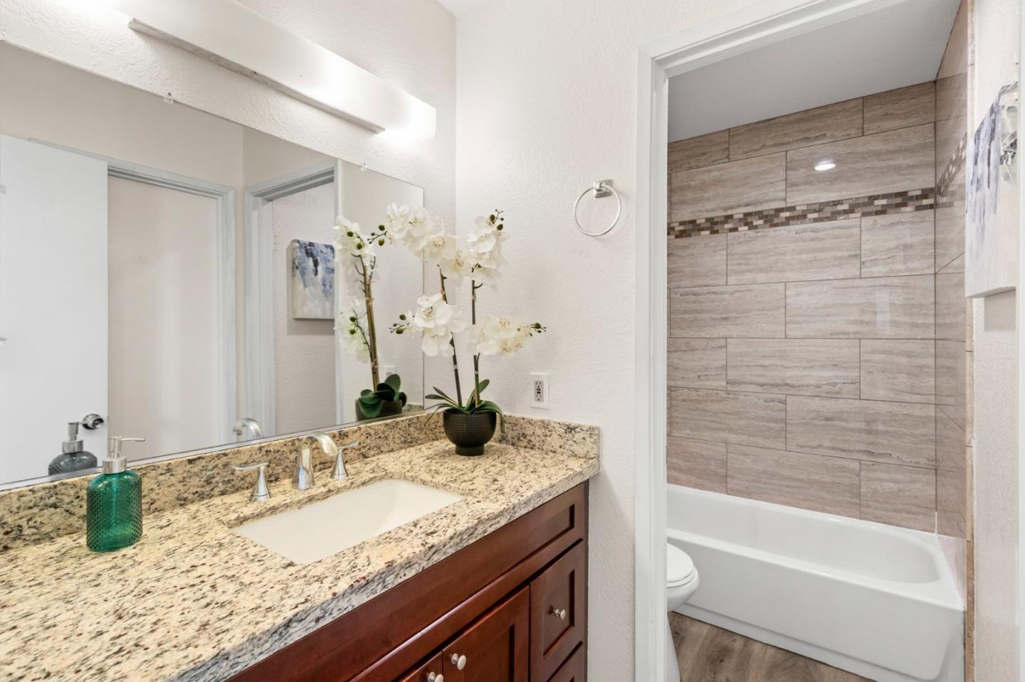 643 Foster Court, Unit 4 Hayward, CA 94544 - Photo 11 of 20 a bathroom with a granite countertop sink and a mirror