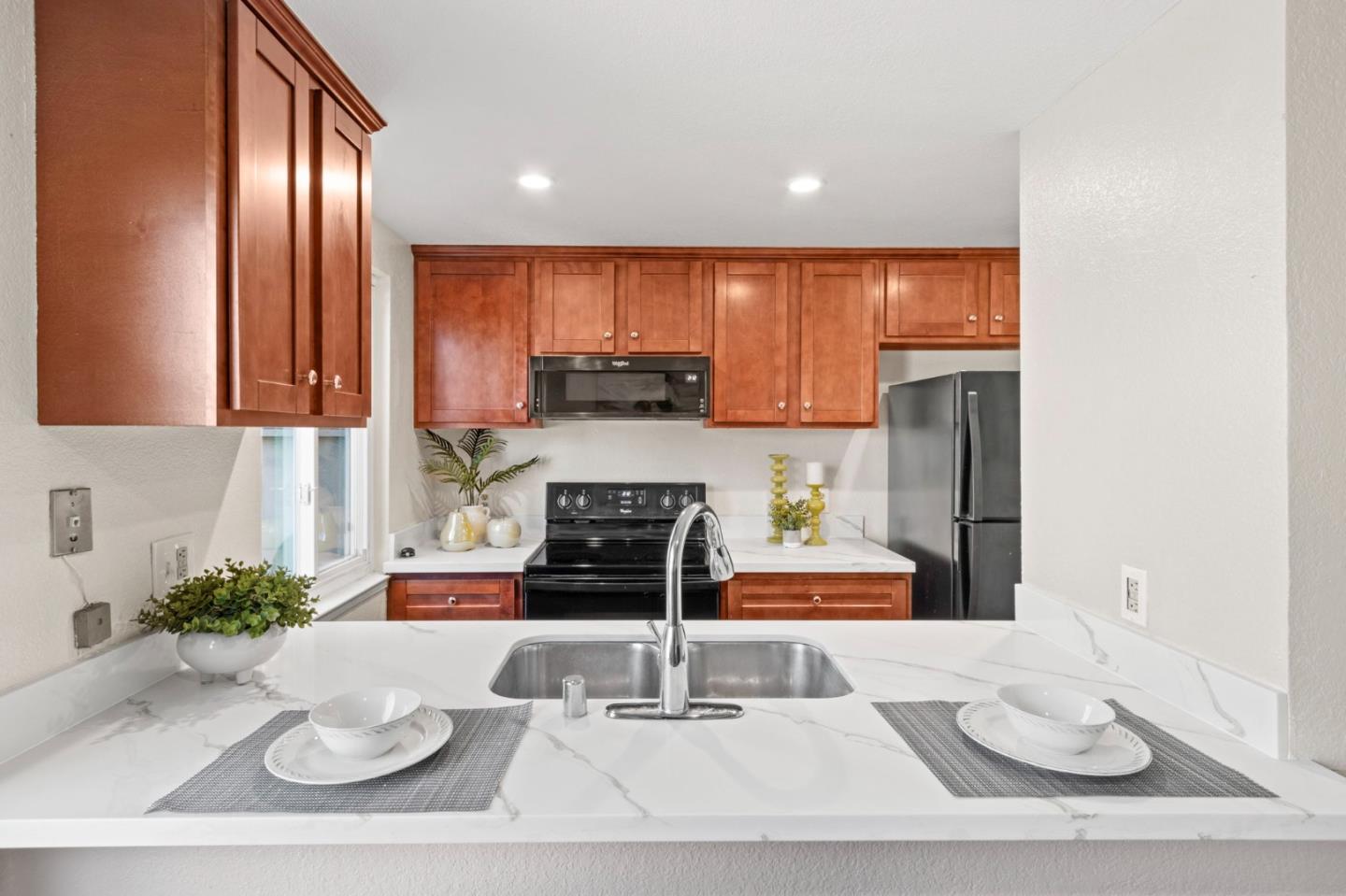 643 Foster Court, Unit 4 Hayward, CA 94544 - Photo 6 of 20 a kitchen with stainless steel appliances kitchen island granite countertop a refrigerator a stove a sink and white cabinets with wooden floor
