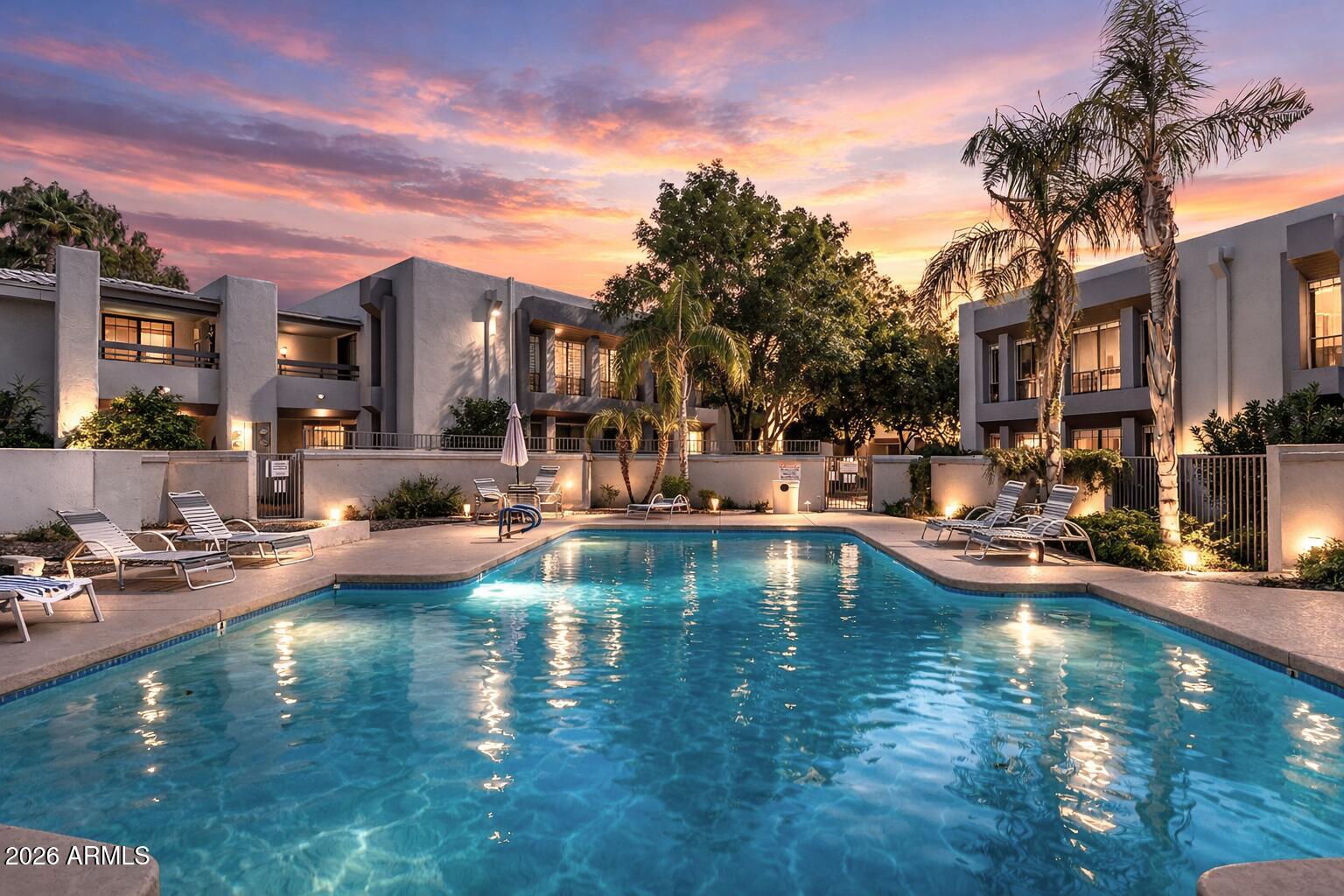 a view of a swimming pool with outdoor seating