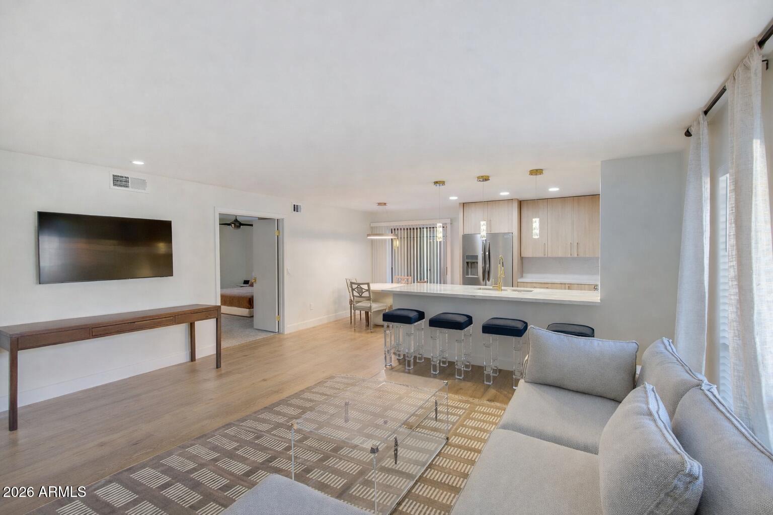 5201 North 24th Street, Unit 107 Phoenix, AZ 85016 - Photo 2 of 15 a living room with furniture and a flat screen tv