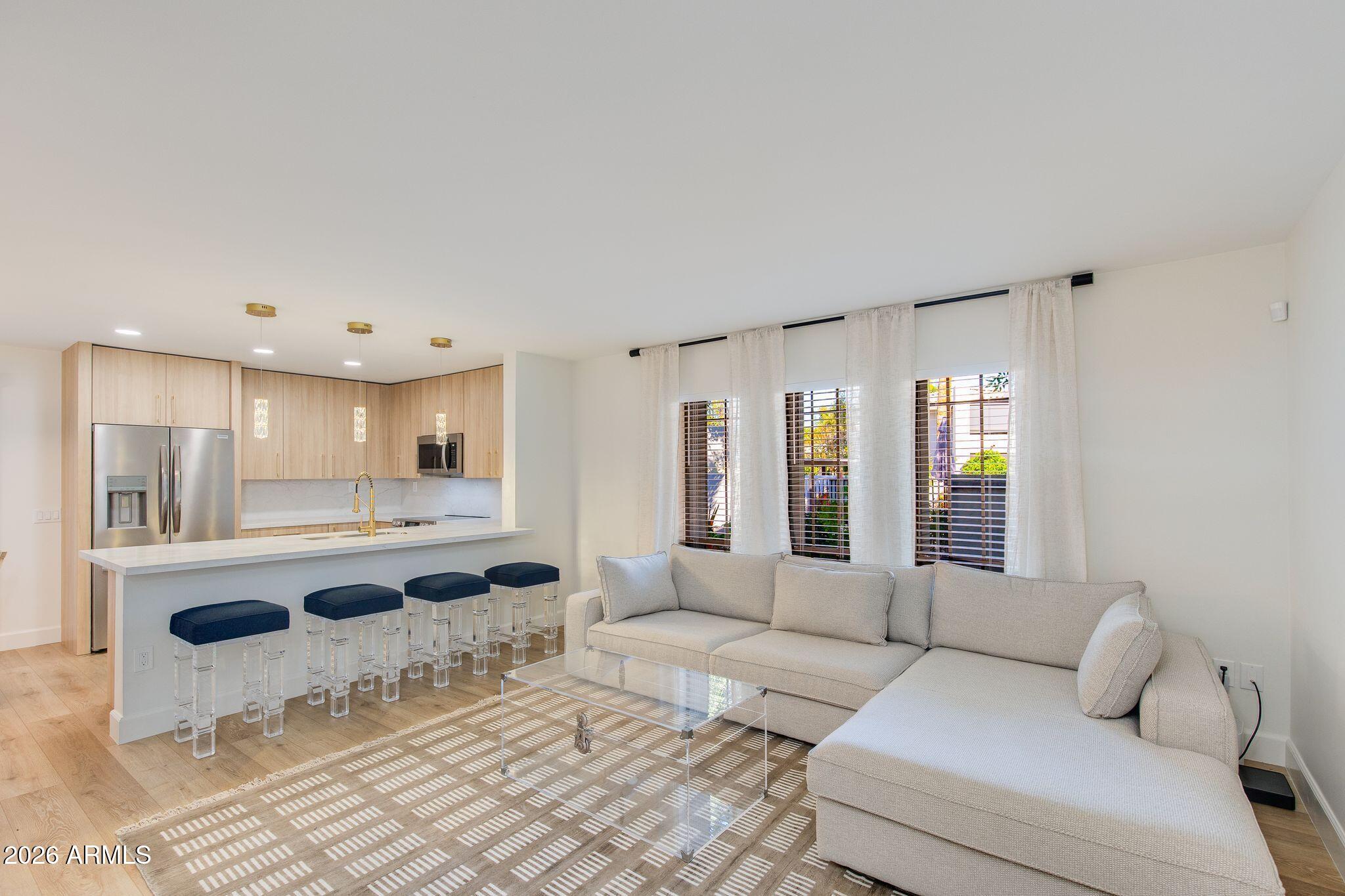 5201 North 24th Street, Unit 107 Phoenix, AZ 85016 - Photo 3 of 15 a living room with furniture and kitchen view
