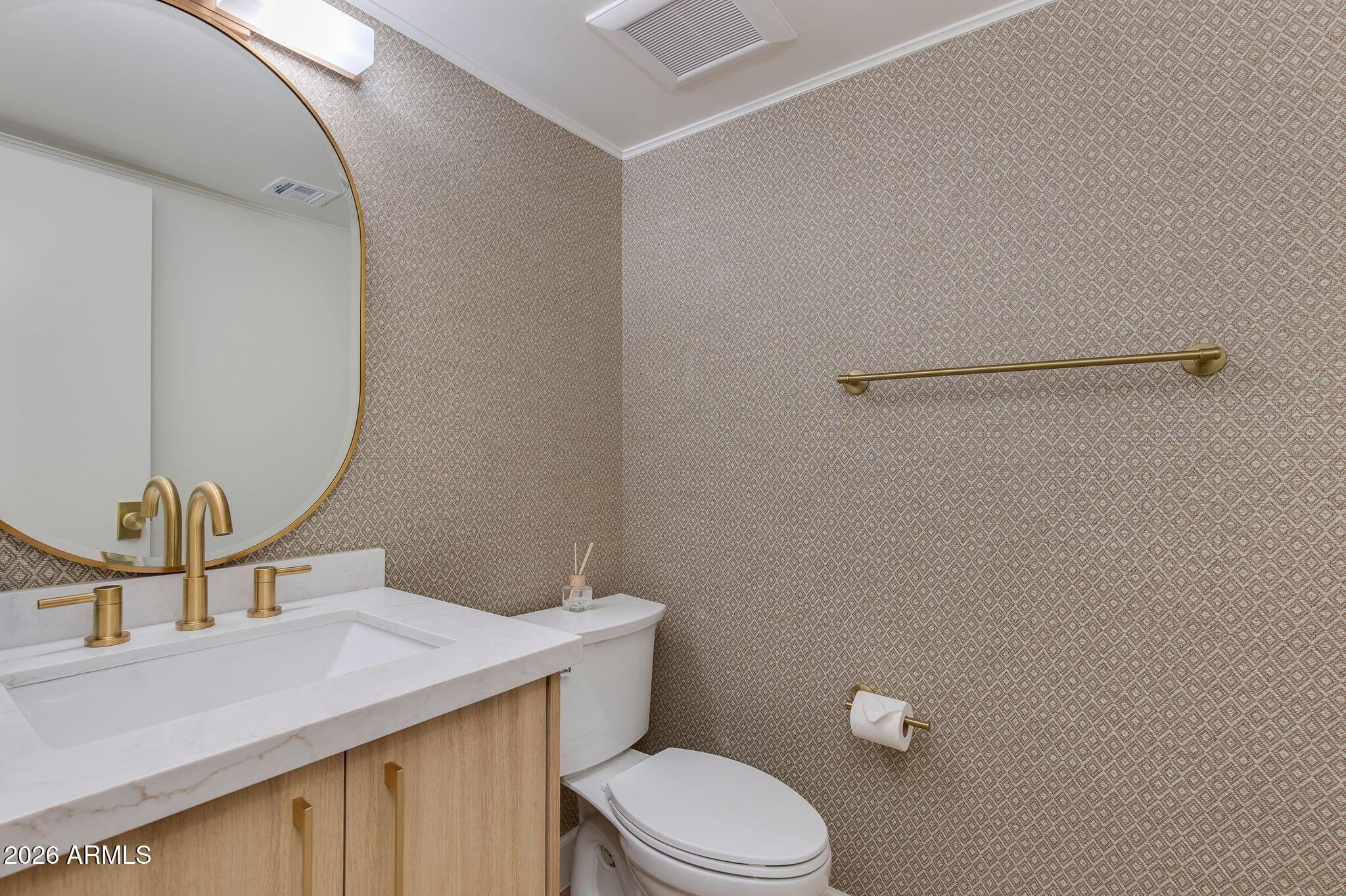 5201 North 24th Street, Unit 107 Phoenix, AZ 85016 - Photo 7 of 15 a bathroom with a toilet a sink and mirror
